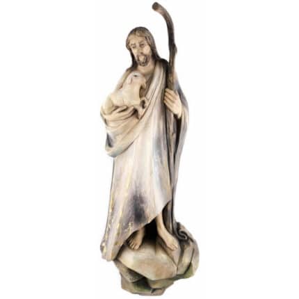 Viktor-Art Good Shepherd (model 2) is a wooden sculpture of a bearded man in a robe, barefoot on rocky ground, holding a crook and lamb. With a gentle expression, this Good Shepherd makes a unique gift for someone special. Exclusive Woodcarving